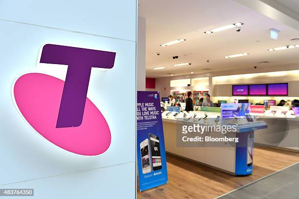 The Telstra Corp. Logo is displayed at a retail store in Melbourne, Australia, on Thursday, Aug. 13, 2015. Telstra posted profit that met analysts'...