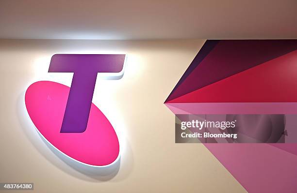 The Telstra Corp. Logo is displayed inside a retail store in Melbourne, Australia, on Thursday, Aug. 13, 2015. Telstra posted profit that met...