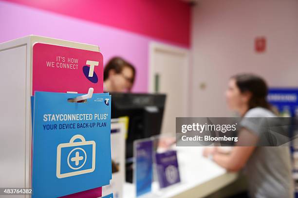 Promotional material for Telstra Corp.'s StayConnected data service is displayed at a counter inside a Telstra retail store in Melbourne, Australia,...