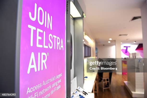 An advertisement for the Telstra Air Wi-Fi network is displayed inside a Telstra Corp. Retail store in Melbourne, Australia, on Thursday, Aug. 13,...