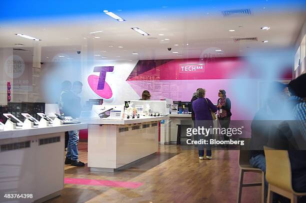 Customers shop inside a Telstra Corp. Retail store in Melbourne, Australia, on Thursday, Aug. 13, 2015. Telstra posted profit that met analysts'...