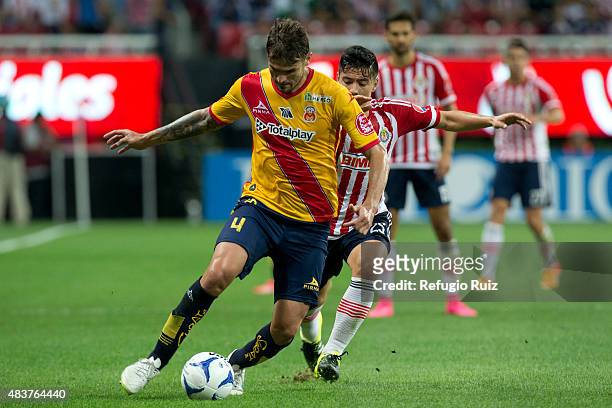 Michael Perez of Chivas fights for the ball with Marco Torsiglieri of Morelia during a 4th round match between Chivas and Morelia as part of the...