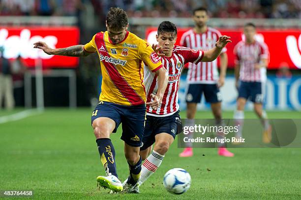 Michael Perez of Chivas fights for the ball with Marco Torsiglieri of Morelia during a 4th round match between Chivas and Morelia as part of the...