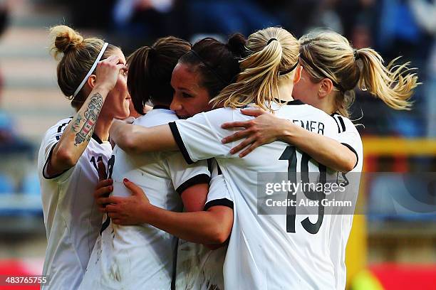 Lena Lotzen of Germany celebrates his team's third goal with team mates during the FIFA Women's World Cup 2015 qualifying match between Germany and...