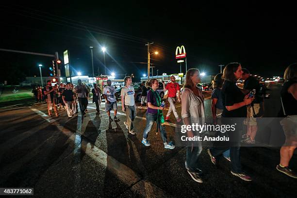 Group of protester gather along West Florissant Avenue and block the street marking the one-year anniversary of the shooting of Michael Brown, in...