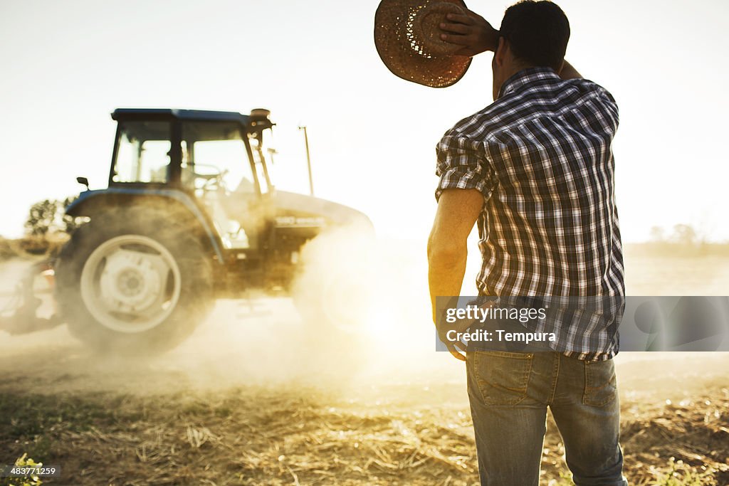 Farmer and tractor working in the fields.