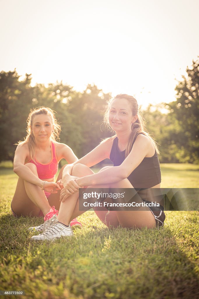 Two woman stretching at the park