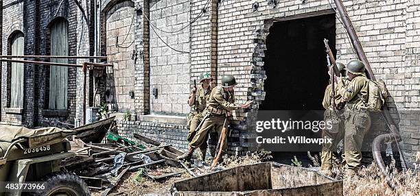 wwii us army soldier throwing hand grenade into building - old ruin stock pictures, royalty-free photos & images