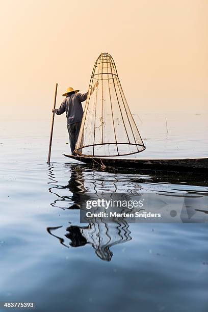fisherman on lake lifting cone shaped net - shan states stock pictures, royalty-free photos & images