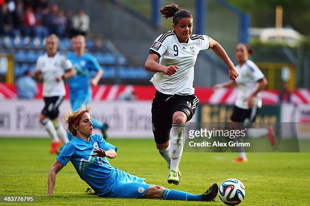 Lena Lotzen of Germany eludes Manja Benak of Slovenia during the FIFA Women's World Cup 2015 qualifying match between Germany and Slovenia at...