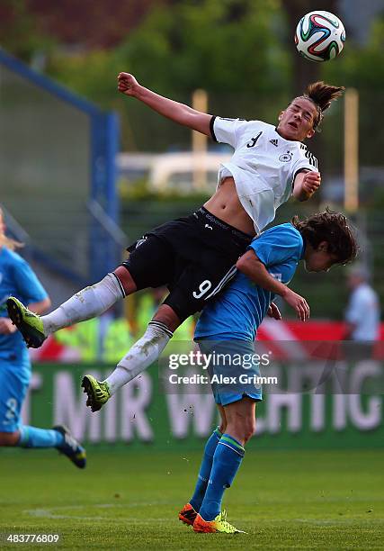 Lena Lotzen of Germany outjumps Mateja Zver of Slovenia during the FIFA Women's World Cup 2015 qualifying match between Germany and Slovenia at...