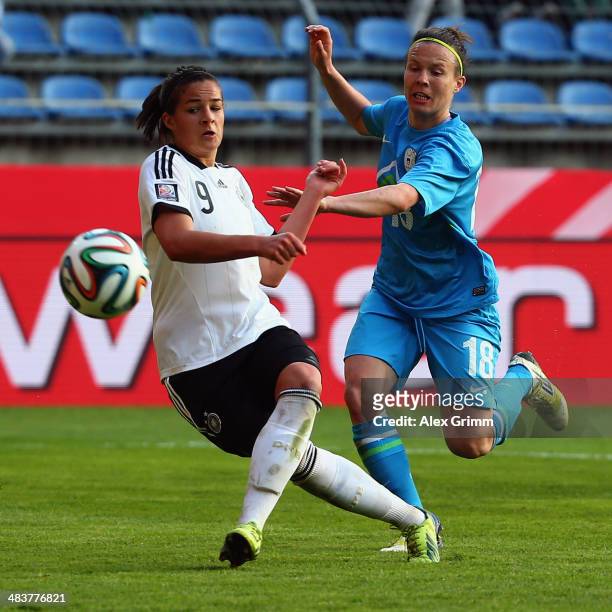 Lena Lotzen of Germany tries to score against Tjasa Tibaut of Slovenia during the FIFA Women's World Cup 2015 qualifying match between Germany and...