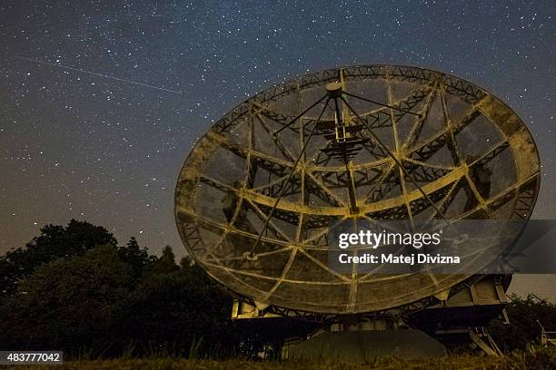 Just about visible Perseid meteor streaks across the sky over the radar near the Astronomical Institute of the Academy of Science of the Czech...