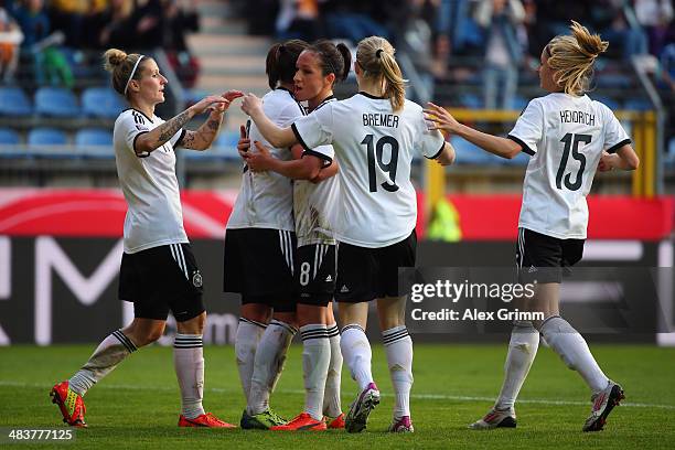 Lena Lotzen of Germany celebrates his team's third goal with team mates during the FIFA Women's World Cup 2015 qualifying match between Germany and...