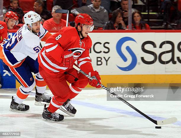 Andrei Loktionov of the Carolina Hurricanes carries the puck during their NHL game against the New York Islanders at PNC Arena on March 25, 2014 in...