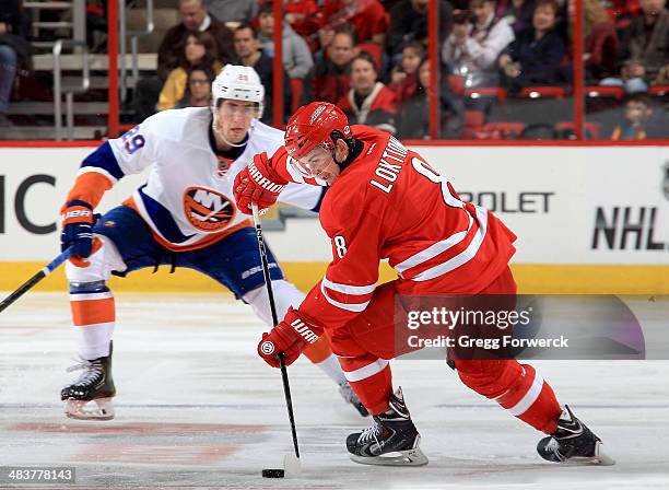 Andrei Loktionov of the Carolina Hurricanes controls the puck on the ice during their NHL game against the New York Islanders at PNC Arena on March...