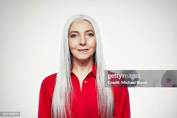 head and shoulders portrait of mature woman - red shirt stock pictures, royalty-free photos & images
