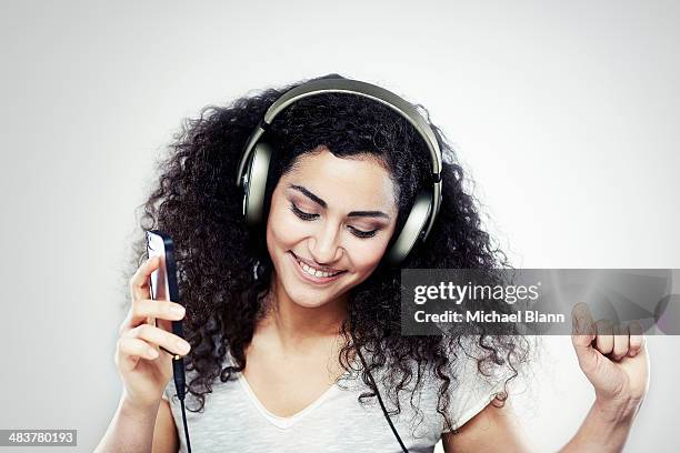 a girl listening to music with headphones on - paying attention stock pictures, royalty-free photos & images