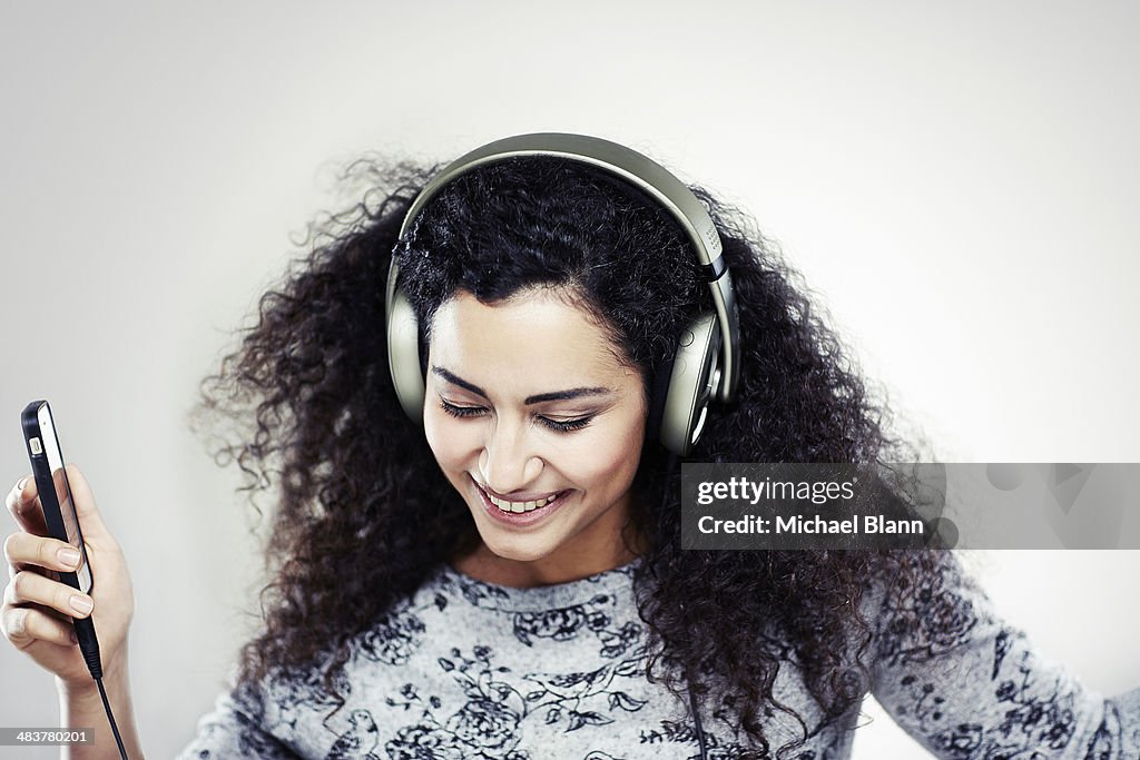 A girl listening to music with headphones on
