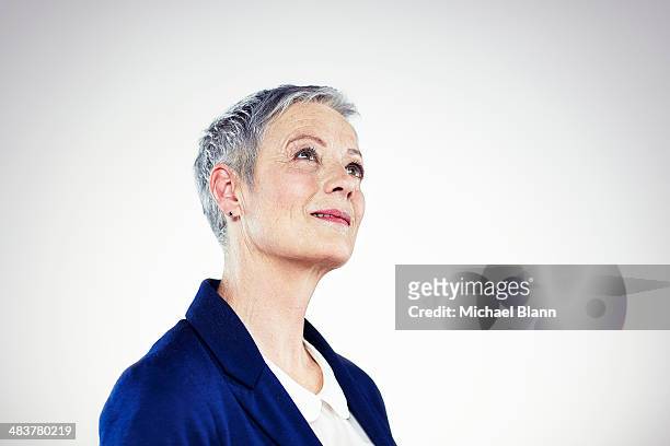 head and shoulders portrait of mature woman - woman looking up bildbanksfoton och bilder