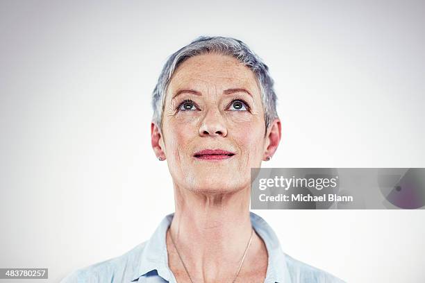 head and shoulders portrait of mature woman - woman with white shirt stock pictures, royalty-free photos & images