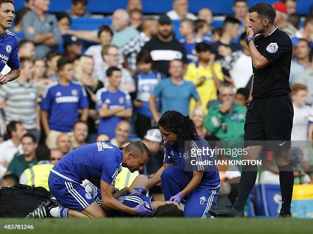Chelsea doctor Eva Carneiro and head physio Jon Fearn treat Chelsea's Belgian midfielder Eden Hazard late on next to referee Michael Oliver during...
