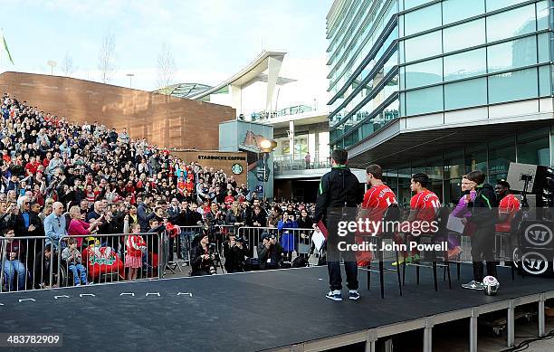 Philippe Coutinho, Jordan Henderson, Simon Mignolet and Kolo Toure of Liverpool present the new home kit for next season at Liverpool One on April...