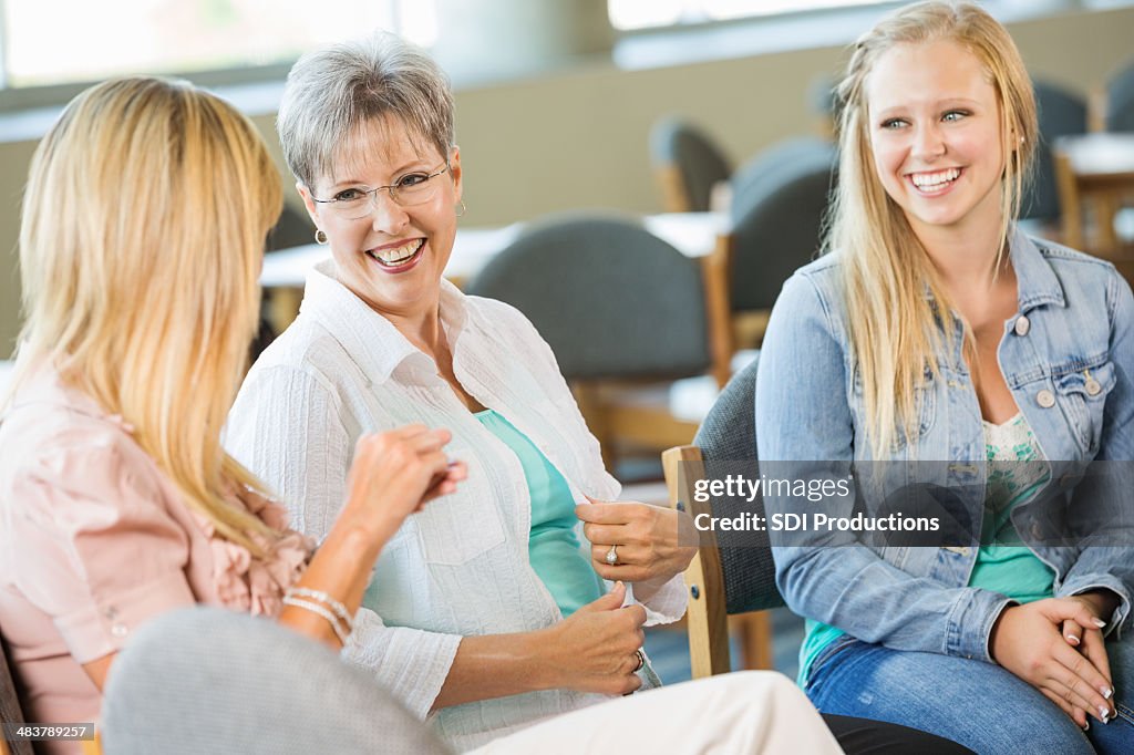 Diverse group of women discussing something together