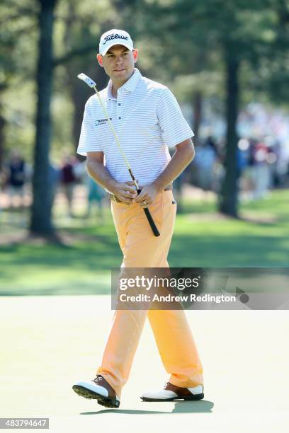 Bill Haas of the United States watches a putt on the first green during the first round of the 2014 Masters Tournament at Augusta National Golf Club...