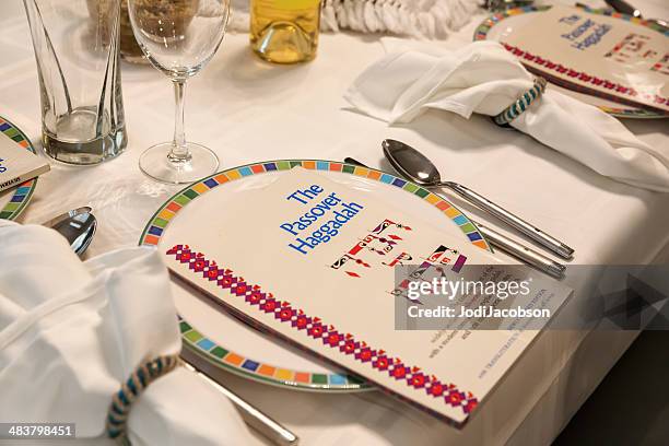 traditional passover seder table with haggadah - pesach seder stock pictures, royalty-free photos & images