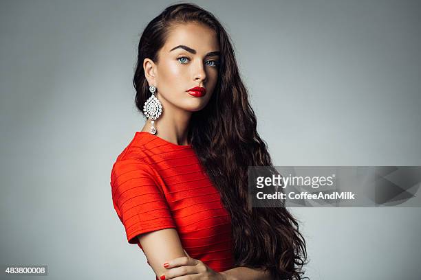 studio shot of young beautiful woman - red dress model stock pictures, royalty-free photos & images