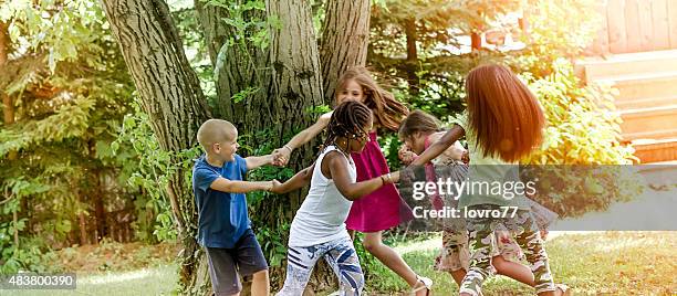 kids running in the park - summer of 77 stock pictures, royalty-free photos & images