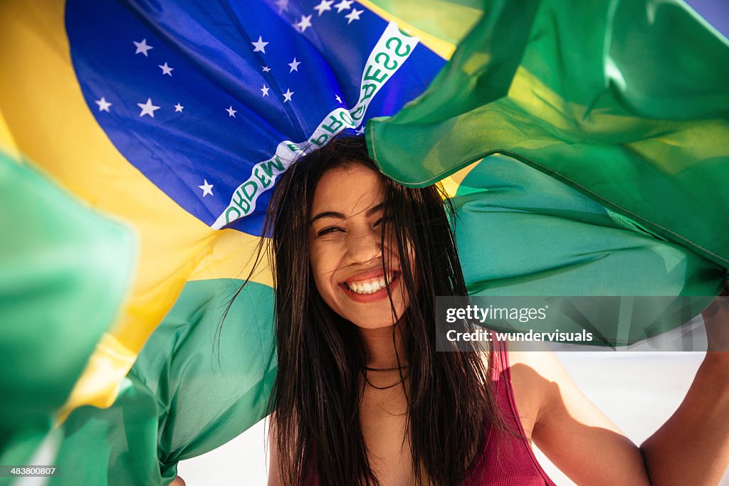 Cheering woman under brazilian flag