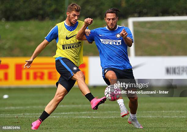 Danilo D Amombrosio competes with Davide Santon during FC Internazionale training session at the club's training ground on August 13, 2015 in Appiano...