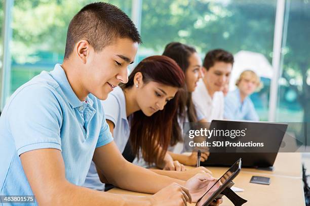 private school teenage students using digital tablets in class - middle school stock pictures, royalty-free photos & images