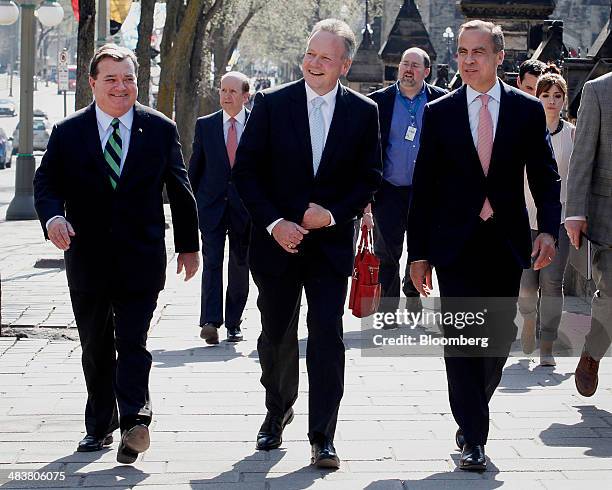 Jim "James" Flaherty, Canada's finance minister, from left, Stephen Poloz, incoming governor of the Bank of Canada, and Mark Carney, outgoing...