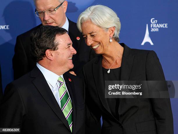 Jim "James" Flaherty, Canada's finance minister, left and Christine Lagarde, managing director of the International Monetary Fund , chat before...