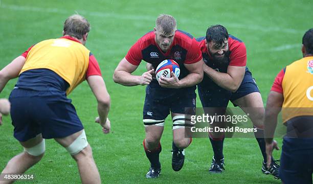 George Kruis attacks with team mate Alex Corbisiero in support during the England training session held at Pennyhill Park on August 13, 2015 in...