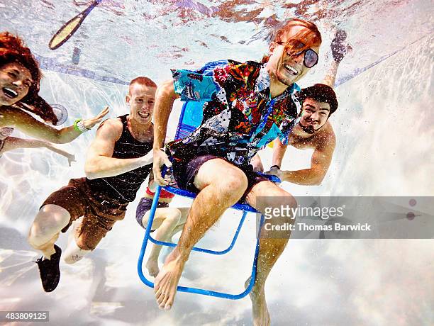 group of young friends underwater in pool - fun stock-fotos und bilder