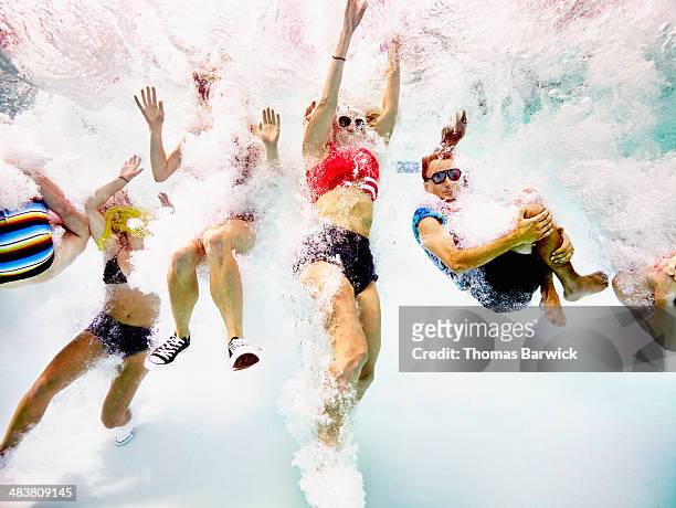 group of young friends jumping into pool - rebellion stock pictures, royalty-free photos & images