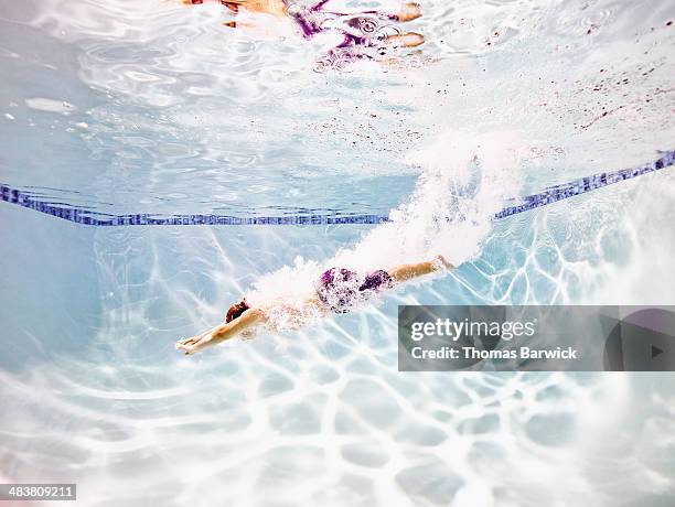 young male swimmer diving into pool - jump in pool stock pictures, royalty-free photos & images