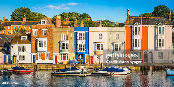 colorful homes quaint cottages in sunny fishing village harbor panorama - beach cottage bildbanksfoton och bilder