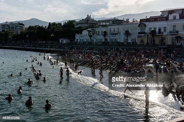 People enjoy one of the beaches on August 10, 2015 in Yalta, Crimea. Russian President Vladimir Putin signed a bill in March 2014 to annexe the...