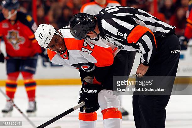 Referee Dave Jackson checks Wayne Simmonds of the Philadelphia Flyers for missing teeth after a collision against the Florida Panthers at the BB&T...