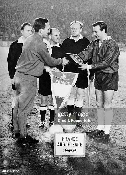 England captain Jimmy Armfield meets the captain of France Andre Lerond watched by the match officials prior to the European Championship 1st round...