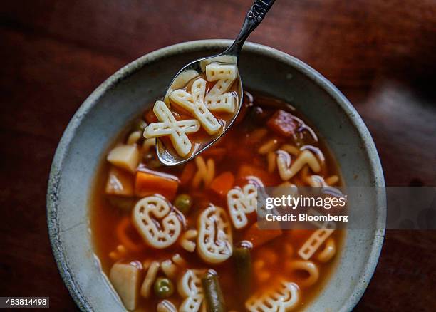 Campbell Soup Co. Letters spell out "XYZ" on a spoon and "COM" in a bowl in this arranged photograph taken in New York U.S., on Wednesday, Aug. 12,...