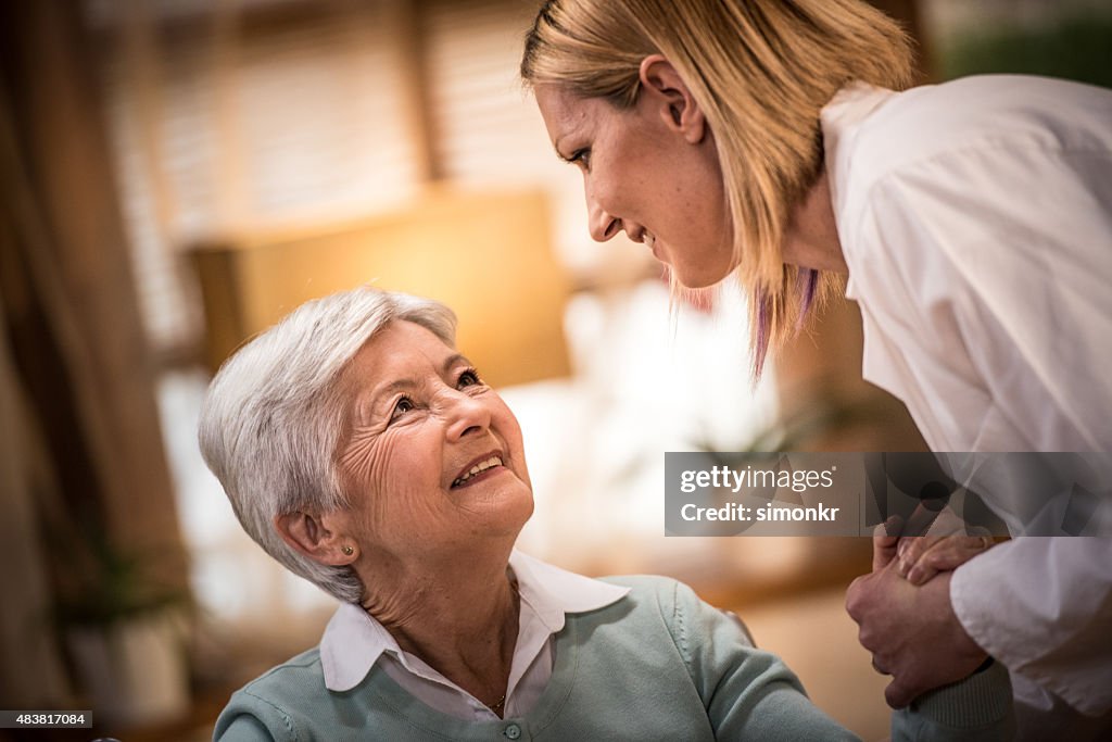 Nurse helping senior woman