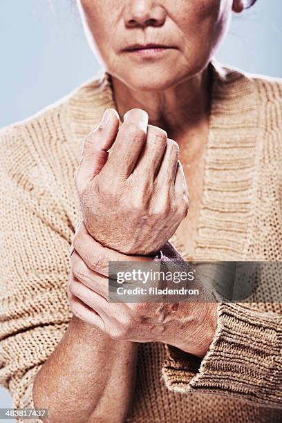 senior in pain - arthritic hands stock pictures, royalty-free photos & images