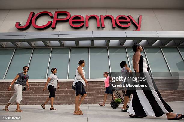 Pedestrians walk past a J.C. Penney Co. Store at the Gateway Shopping Center in the Brooklyn borough of New York, U.S., on Saturday, Aug. 8, 2015....