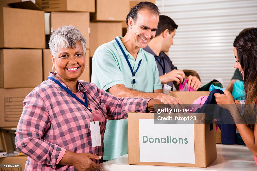 Group of volunteers provide clothing donations to needy families. Charity.